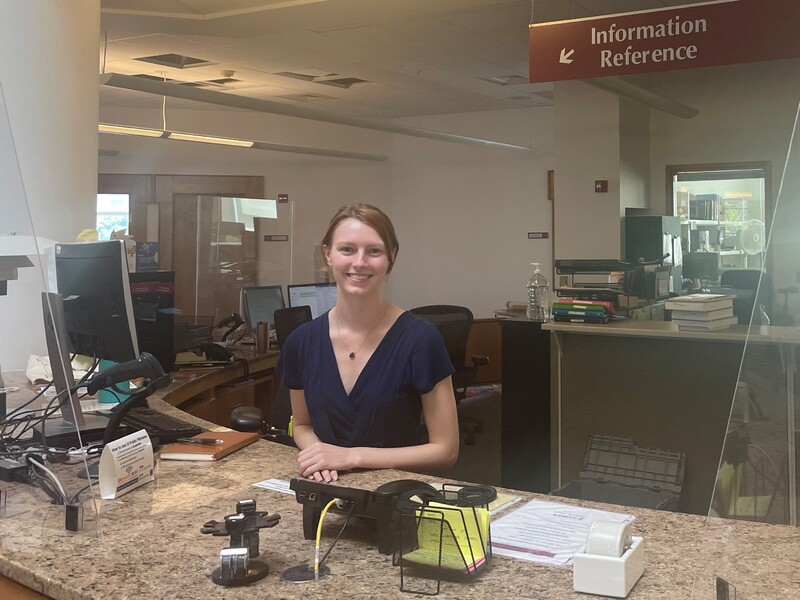 Image of a person behind the circulation desk
