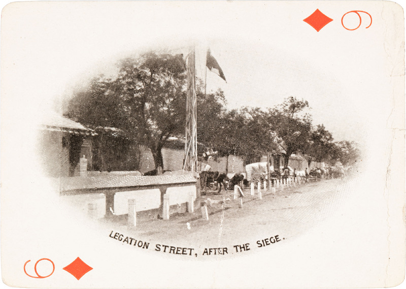 The 6 of diamonds with a picture of a street lined with buildings and trees.