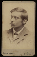 H. G. Wells at the age of 25 looks to the left of the sepia tone torso portrait. Wells is wearing a collared suit and has a long mustache.