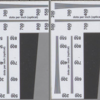 Two photographs zoomed into the center of an item level target where the optical resolution converging lines arranged vertically and horizontally that show dots per inch resolving power of an image illustrate that lines are distinctly visible past 600 on the left and only just past 500 on the right -- the gray slant lines to the bottom right on both have a left/top that's a darker gray portion of a vertical rectangle, and a lighter gray portion for the right/bottom portion.