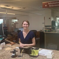 Image of a person behind the circulation desk
